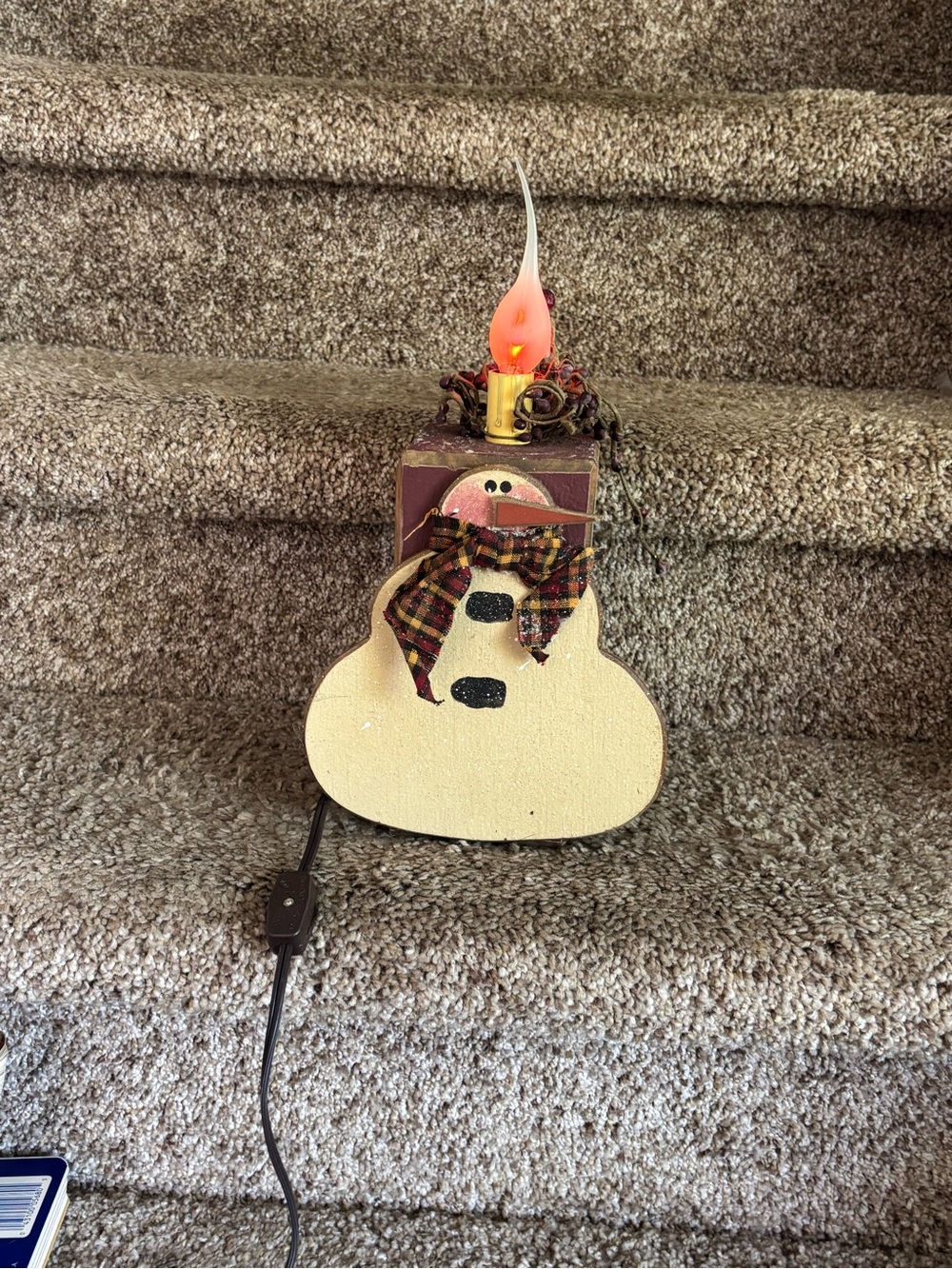 Wooden snowman with electric candle